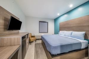 Postel nebo postele na pokoji v ubytování Scottish Inns-Campus