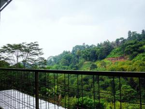 a balcony with a view of a mountain at The Wiltshire Dago Pakar - Hillside Villa MAX 12 ORANG in Bandung