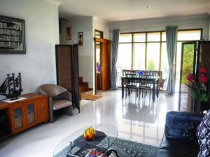 a living room with a couch and a table at The Wiltshire Dago Pakar - Hillside Villa MAX 12 ORANG in Bandung +11 photos