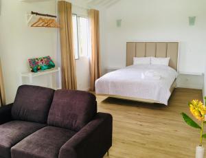 a living room with a couch and a bed at Azores Casa Atlantis in Nordeste