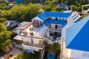 an aerial view of a house with a blue roof at Atriy Hotel in Simeiz