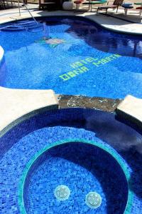 a large swimming pool with blue water in it at Hotel Doña Marta in Nicoya