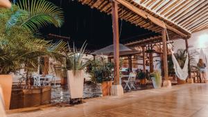 a patio with potted plants and tables and chairs at Misia Custodia Hotel Boutique in Barichara