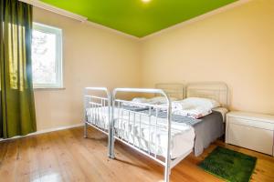 a bedroom with two bunk beds and a green ceiling at Guest House Bolnisi - Colorful Apartment in Bolnisi
