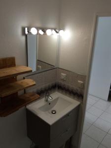 a bathroom with a sink and a mirror at T3 VUE ETANG in Balaruc-les-Bains