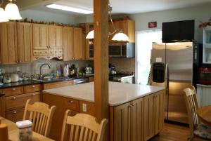 a kitchen with wooden cabinets and a large counter top at Stamford Gables Bed and Breakfast in Stamford