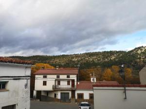 a view of a building with a mountain in the background at Casa rural fuentelgato in Huerta del Marquesado +13 photos