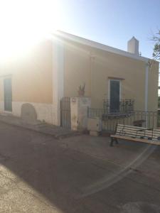 a building with a bench in a parking lot at Casa Calanave 2 in Ventotene