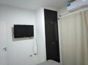 a room with a flat screen tv on a wall at Echague y Cura A Montiel in Paraná