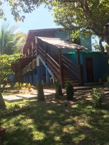 a house with a wooden staircase in front of it at Pousada Tulum in Barra Grande