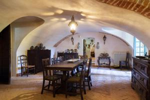a dining room with a table and chairs at Palazzo Sismonda in Corneliano d'Alba