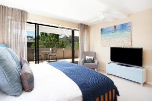 a bedroom with a bed and a flat screen tv at Spacious Family Entertainer for Manly Retreat DUPLICATE in Sydney