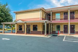a building with a parking lot in front of it at Americas Best Value Inn - Mableton in Mableton