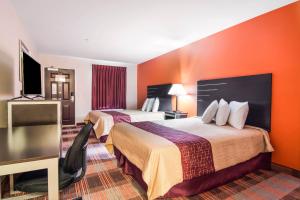 a hotel room with two beds with orange walls at Americas Best Value Inn - Mableton in Mableton
