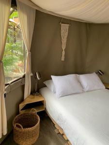 a bedroom with a bed and a window at Hostal de la Luz - Spa Holistic Resort in Tepoztlán