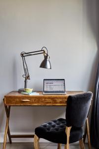 a wooden desk with a lamp and a lamp post at The Collective Paper Factory in Queens