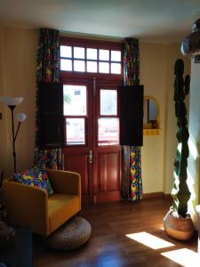 a living room with a chair and a door at Apartamento La Peatonal in San Sebastián de la Gomera
