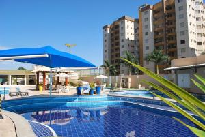 a large swimming pool with buildings in the background at Prive das Thermas I - Achei Ferias in Caldas Novas