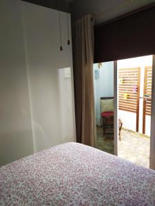 a bedroom with a bed and a view of a room at Apartamento La Peatonal in San Sebastián de la Gomera
