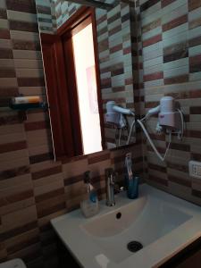 a bathroom sink with a mirror and a window at Apartamento La Peatonal in San Sebastián de la Gomera +20 photos