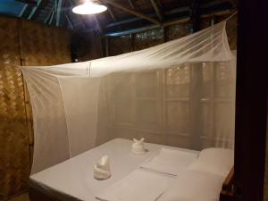 a white table with two white shoes on top of it at Backpacker's Hill Resort in San Vicente