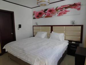 Voodi või voodid majutusasutuse Sunshine Hotel toas