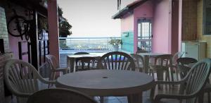 a group of tables and chairs on a patio at Casa Aurora Luz do Amanhecer in Rio de Janeiro