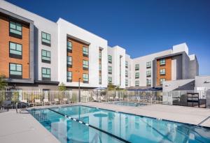 an image of a swimming pool in front of a building at Ayres Hotel San Diego South - Chula Vista in Chula Vista