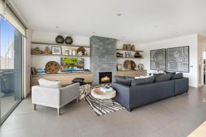 a living room with a couch and a fireplace at Saltwater Apartment Sorrento in Sorrento