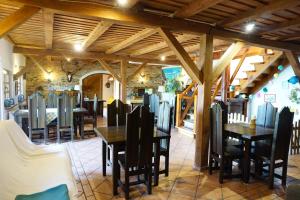 a dining room with wooden tables and chairs at Mazurska Zagroda in Rydzewo