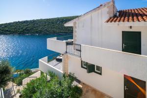 an apartment building with a view of the water at Villa Sine in Sevid +108 photos