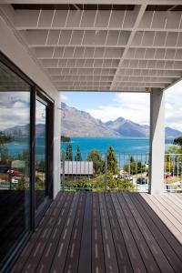a deck with a view of the water at Casa Vista Apartment by Amazing Accom in Queenstown