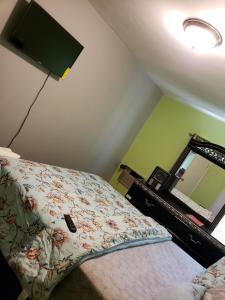 a bedroom with a bed and a lamp and a mirror at Comfortable holiday homestay in Bronx