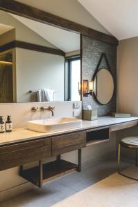 a bathroom with a sink and a large mirror at Gibbston Valley Lodge and Spa in Queenstown
