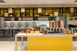 a kitchen with a table with food on it at ibis Styles East Perth in Perth