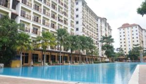 a large swimming pool in front of a building at Homestay Pagar Buruk Bukit Merah L4 - AIR CONDITIONED in Kampong Selemat