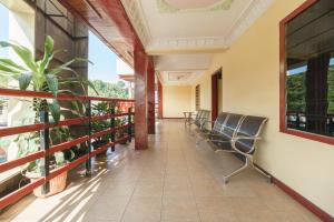 a corridor of a building with chairs on a balcony at RedDoorz @ Parapat in Parapat