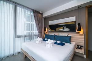 Posteľ alebo postele v izbe v ubytovaní Oceanstone Resort by Lofty + 32 fotografií