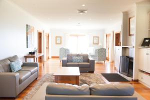 a living room with a couch and a table at Audrey Wilkinson Vineyard in Pokolbin