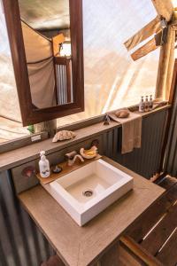 a bathroom counter with a sink and a mirror at Sal Salis Ningaloo Reef in Exmouth