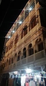 a building with christmas lights in front of a store at Kasera Heritage View in Būndi