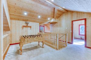 a room with wooden walls and a staircase in a house at Money Creek Lodge - 5 Bed 2 Bath Vacation home in Skykomish in Skykomish