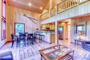 a dining room and kitchen in a log home at Money Creek Lodge - 5 Bed 2 Bath Vacation home in Skykomish in Skykomish