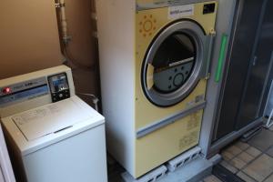 a washing machine sitting next to a washer at Ueno Touganeya Hotel in Tokyo