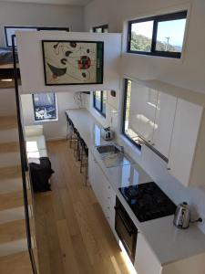 a kitchen with white cabinets and a counter top at Bottletree Gardens - Mini Manson Blue in Gold Coast