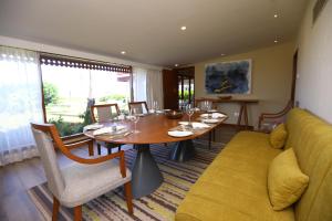 a dining room with a table and a couch at Taj Fisherman’s Cove Resort & Spa, Chennai in Mahabalipuram