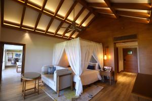 a bedroom with a bed with a canopy at Taj Fisherman’s Cove Resort & Spa, Chennai in Mahabalipuram