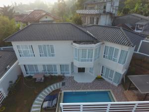 an aerial view of a house with a swimming pool at Nirvana Villas Puncak in Puncak