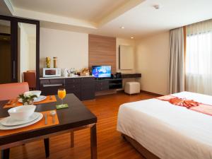 Ένα ή περισσότερα κρεβάτια σε δωμάτιο στο Aspen Suites Hotel Sukhumvit 2