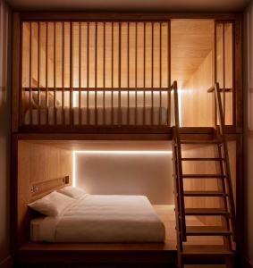 
a bunk bed with a ladder on top of it at Zedwell Piccadilly in London
